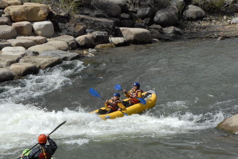 a group of people on a raft in a body of water