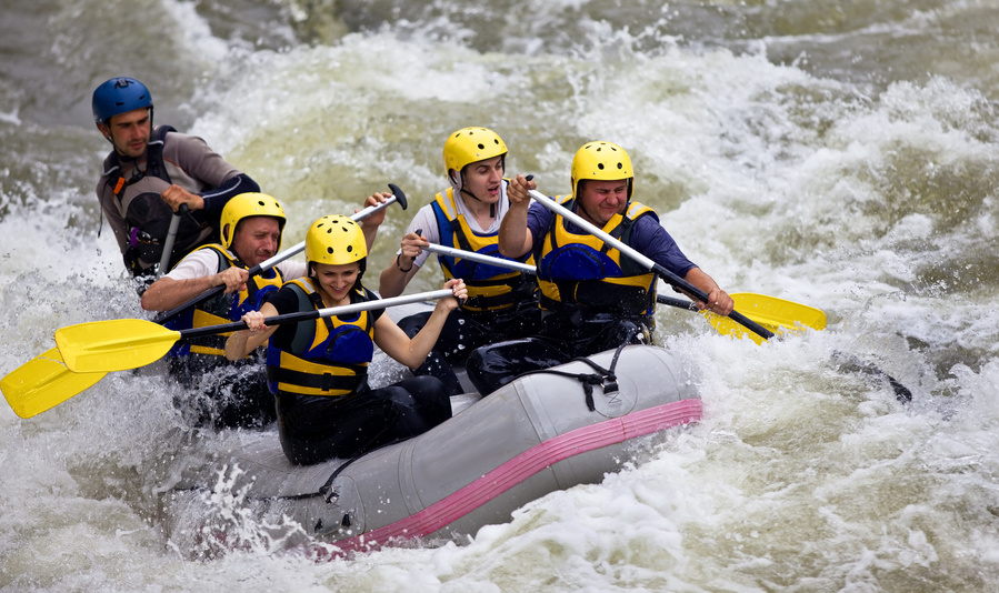 a group of people riding skis on a raft