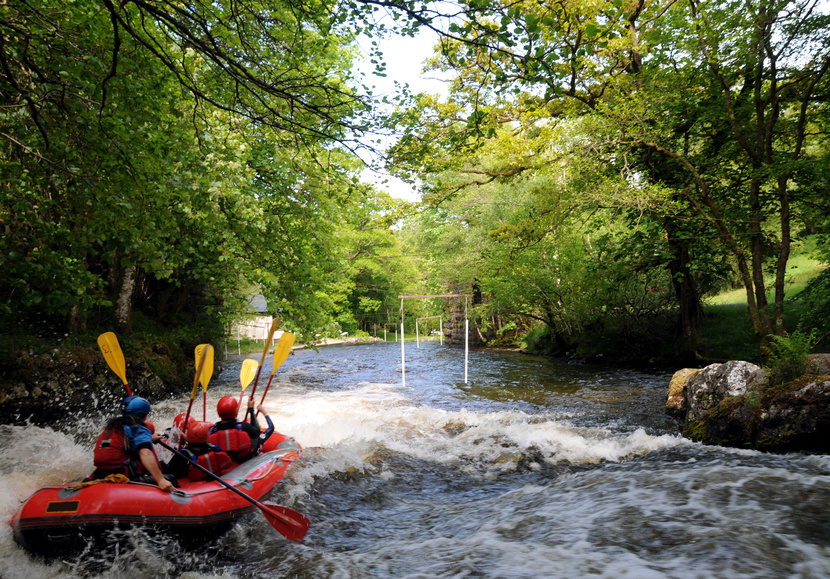 a person sitting on a raft in a forest