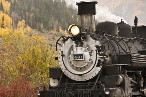 a steam engine train traveling down train tracks