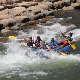 a group of people on a raft in a body of water
