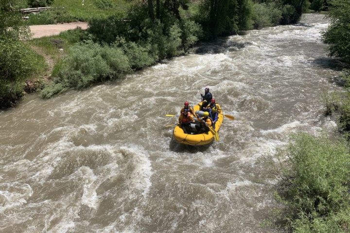 a man riding on a raft in a river