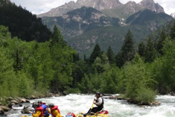 a group of people on a raft in a body of water