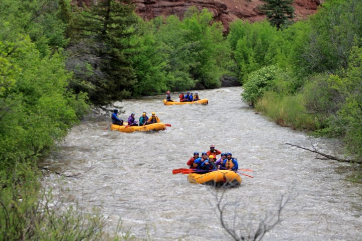 a group of people on a raft in a body of water