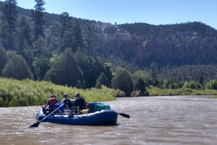 a group of people in a boat on a body of water