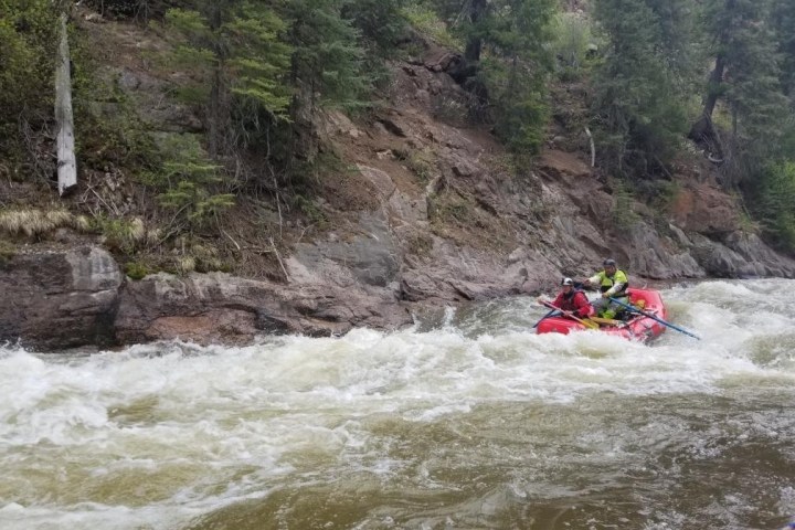a man riding on a raft in a body of water