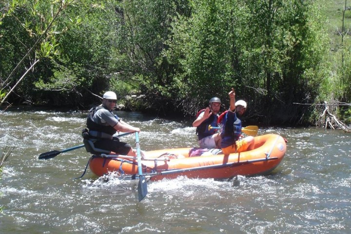 a group of people riding on the back of a boat