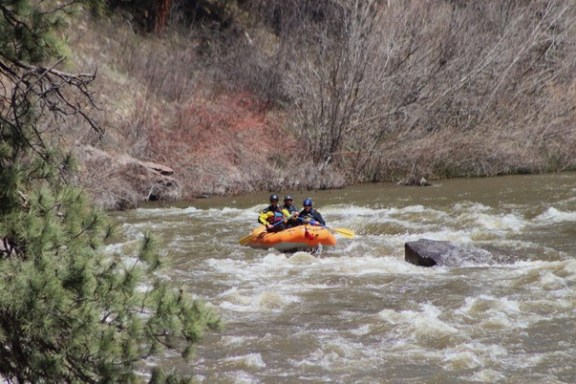 a man riding on a raft in a body of water