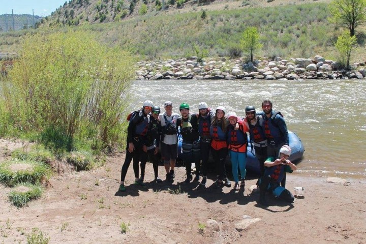 a group of people standing next to a body of water