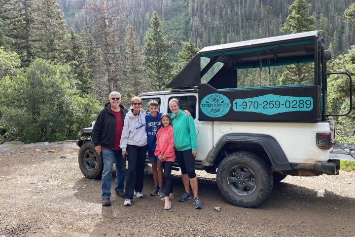 a group of people standing in front of a truck