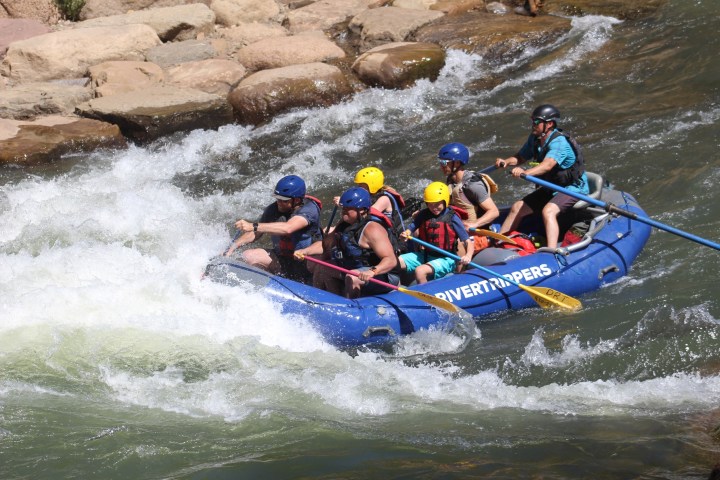 a group of people riding on a raft in a body of water